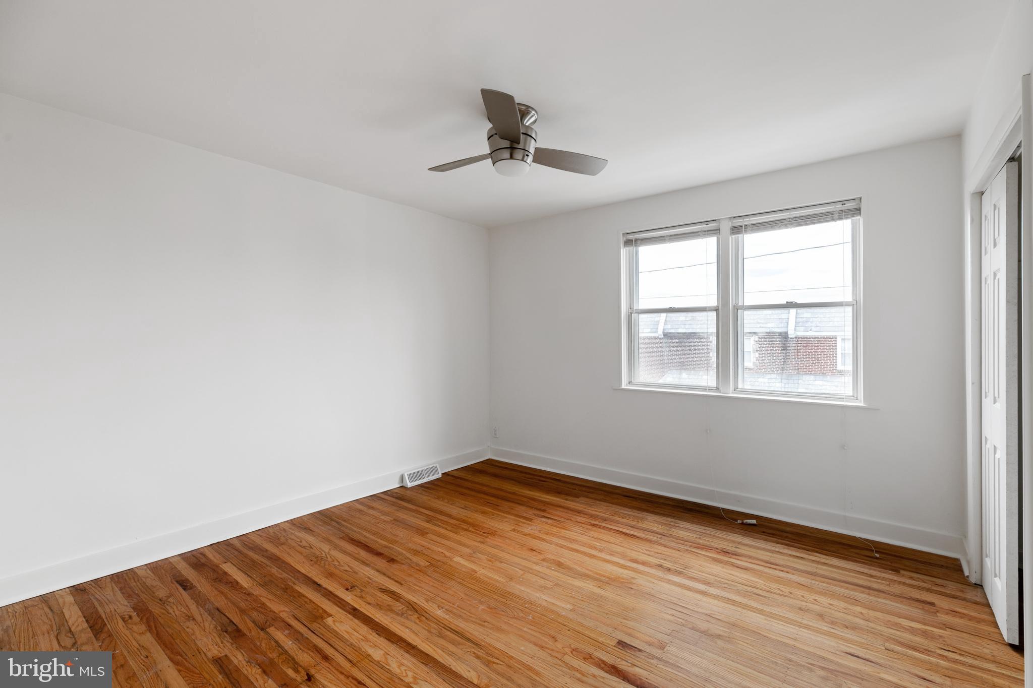 1828 South 29th Street Philadelphia, PA 19145 - Photo 15 of 32 a view of empty room with wooden floor and fan