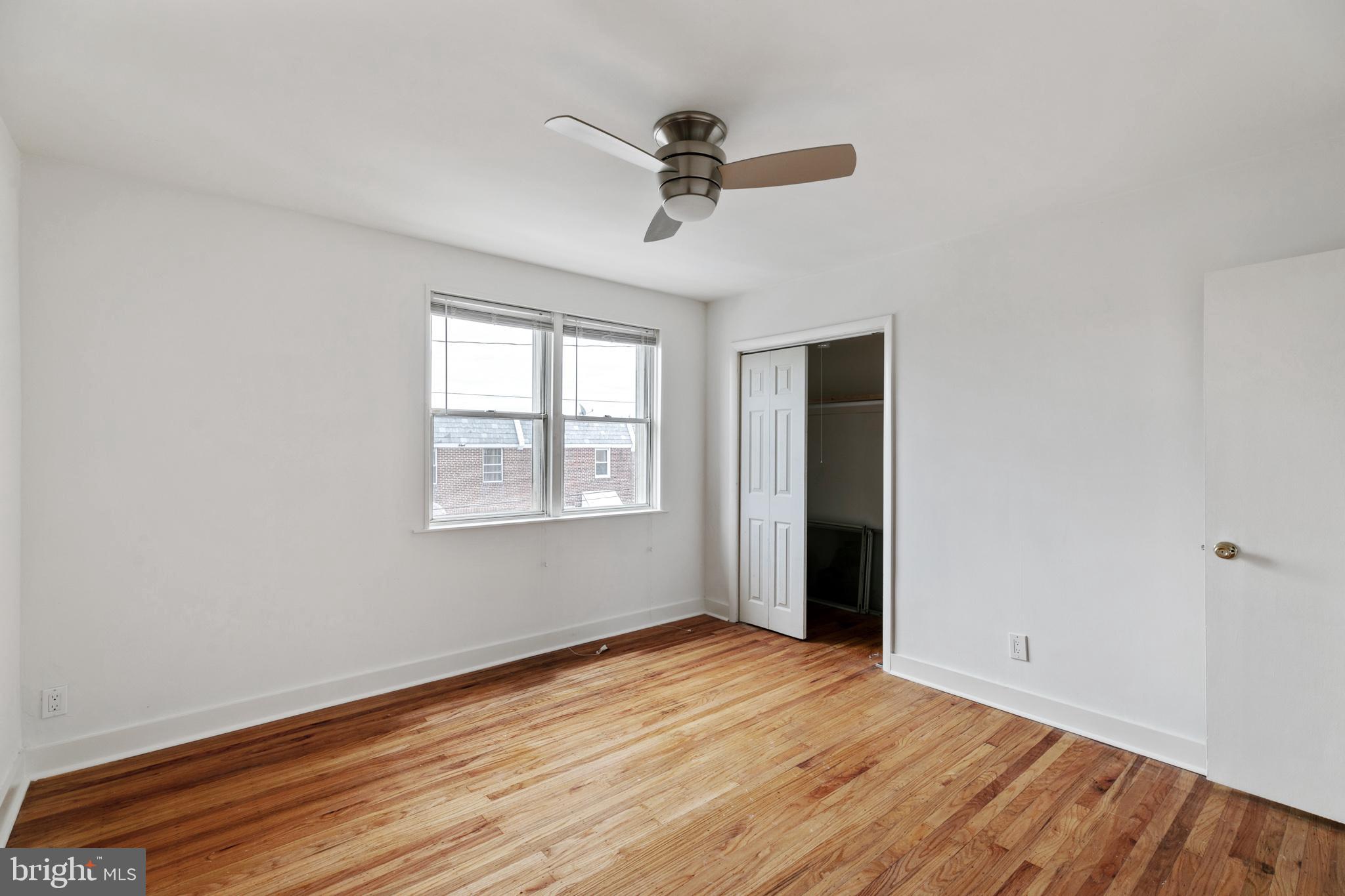 1828 South 29th Street Philadelphia, PA 19145 - Photo 16 of 32 wooden floor in an empty room with a window