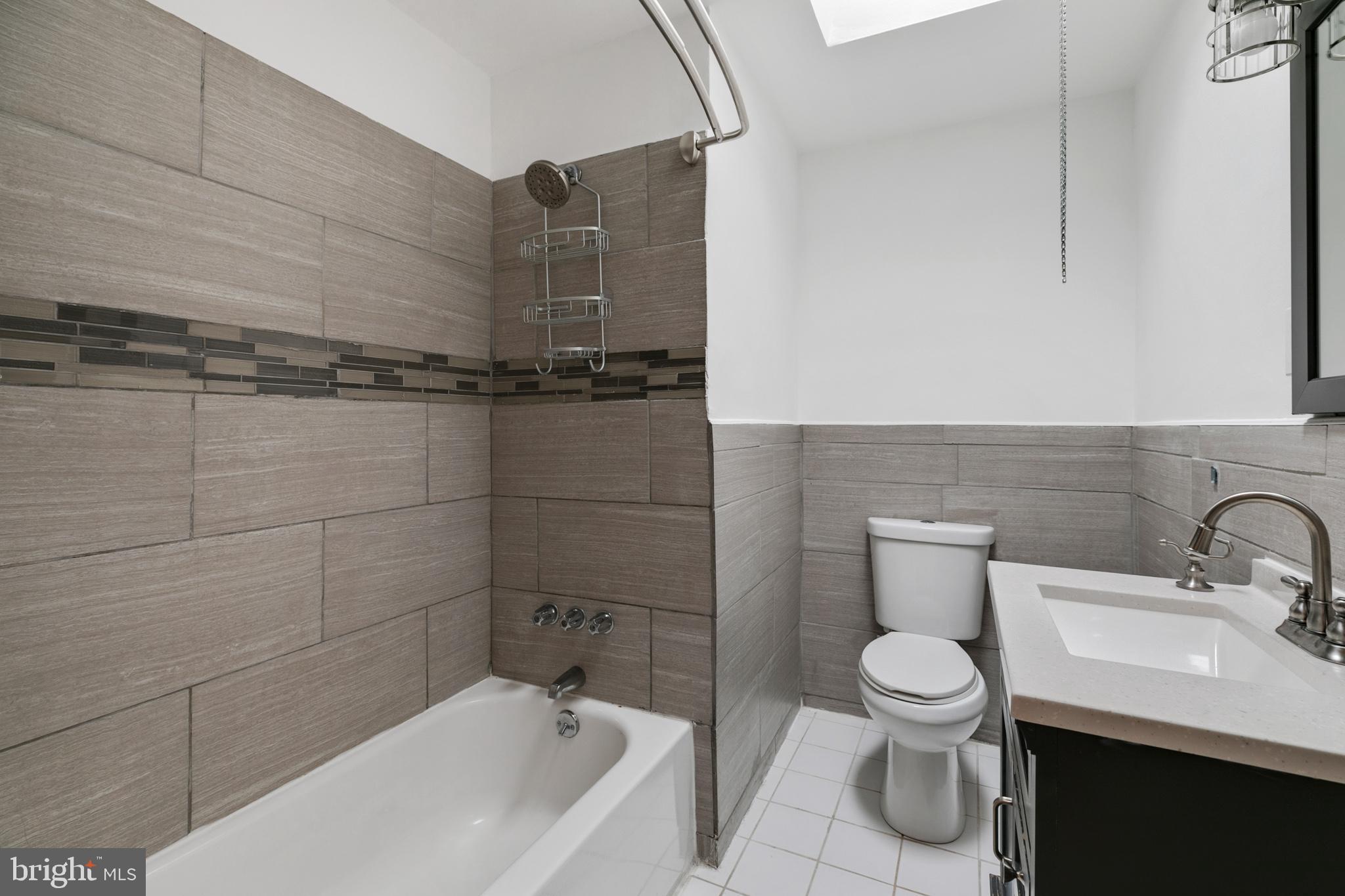 1828 South 29th Street Philadelphia, PA 19145 - Photo 17 of 32 a bathroom with a sink a toilet and bathtub