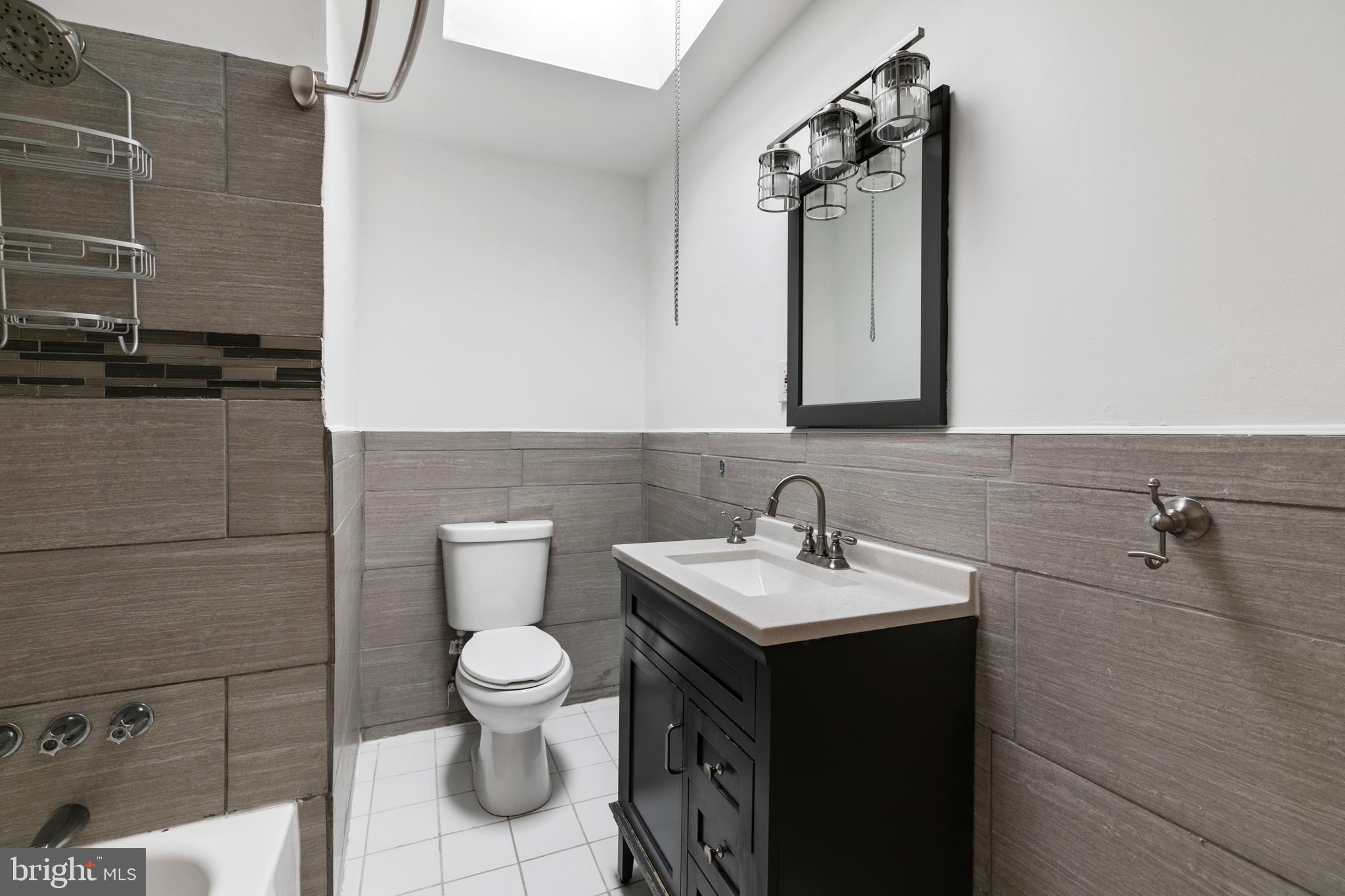 1828 South 29th Street Philadelphia, PA 19145 - Photo 18 of 32 a bathroom with a toilet sink and mirror