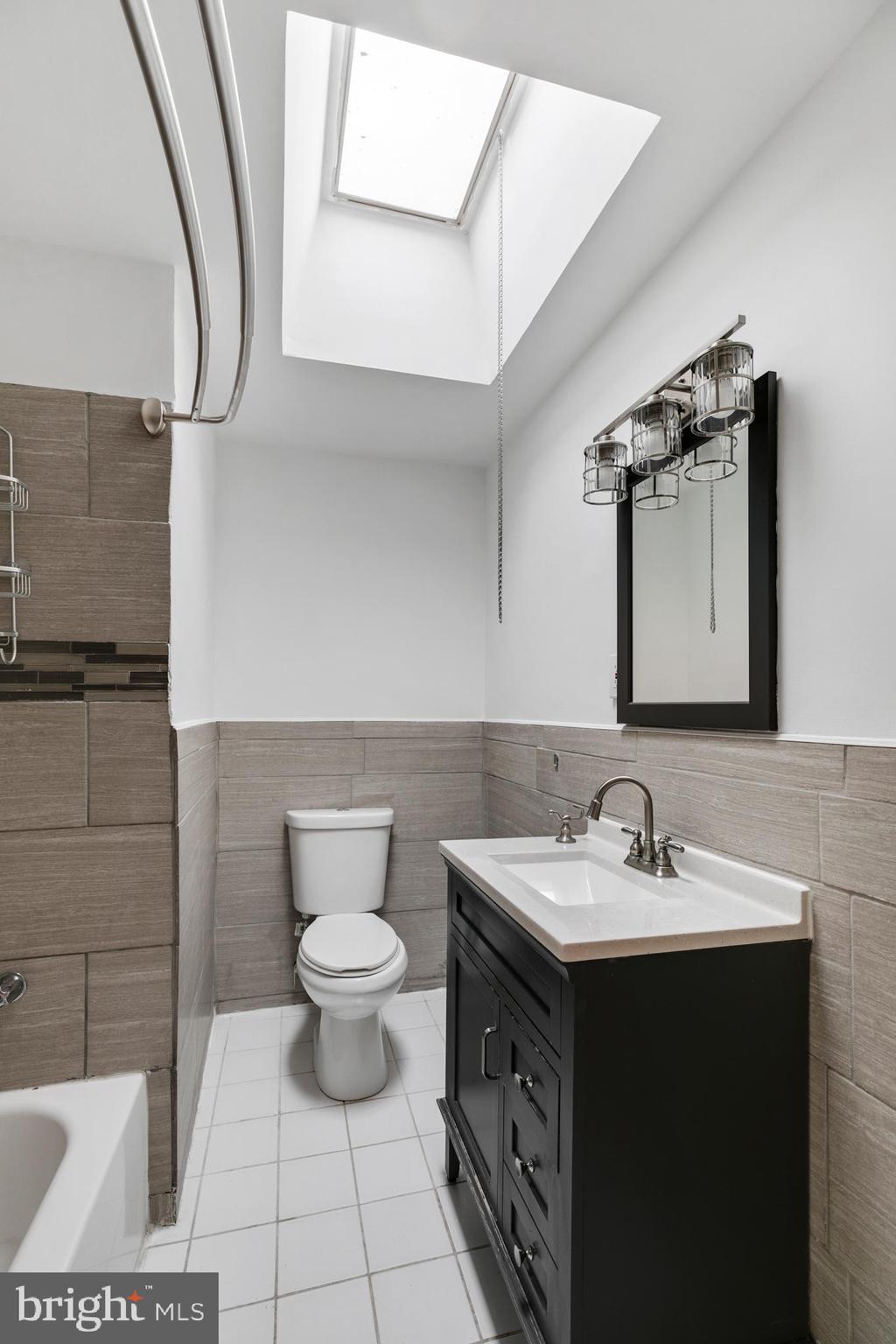 1828 South 29th Street Philadelphia, PA 19145 - Photo 19 of 32 a bathroom with a sink toilet and mirror