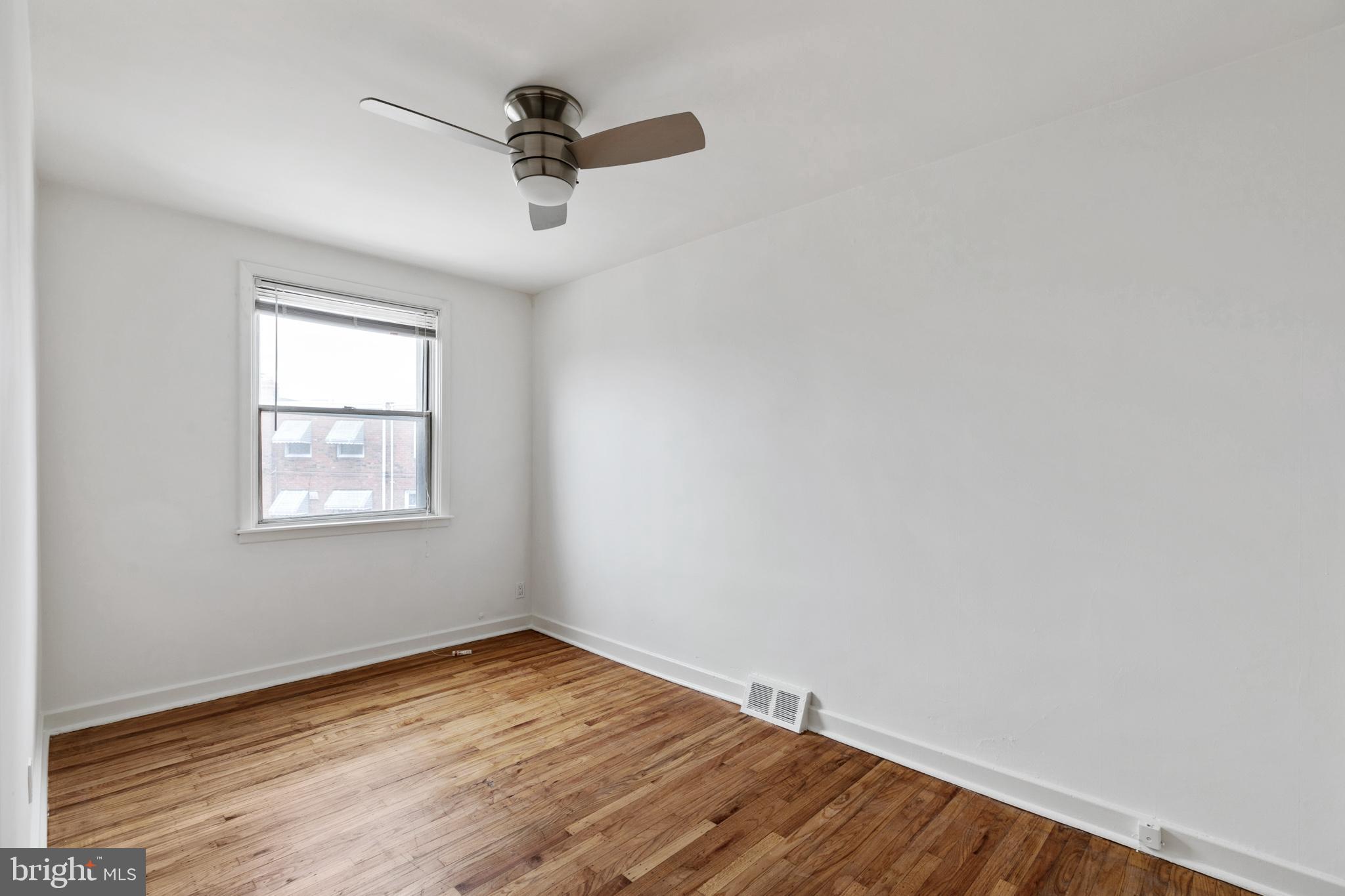 1828 South 29th Street Philadelphia, PA 19145 - Photo 20 of 32 wooden floor in an empty room with a window