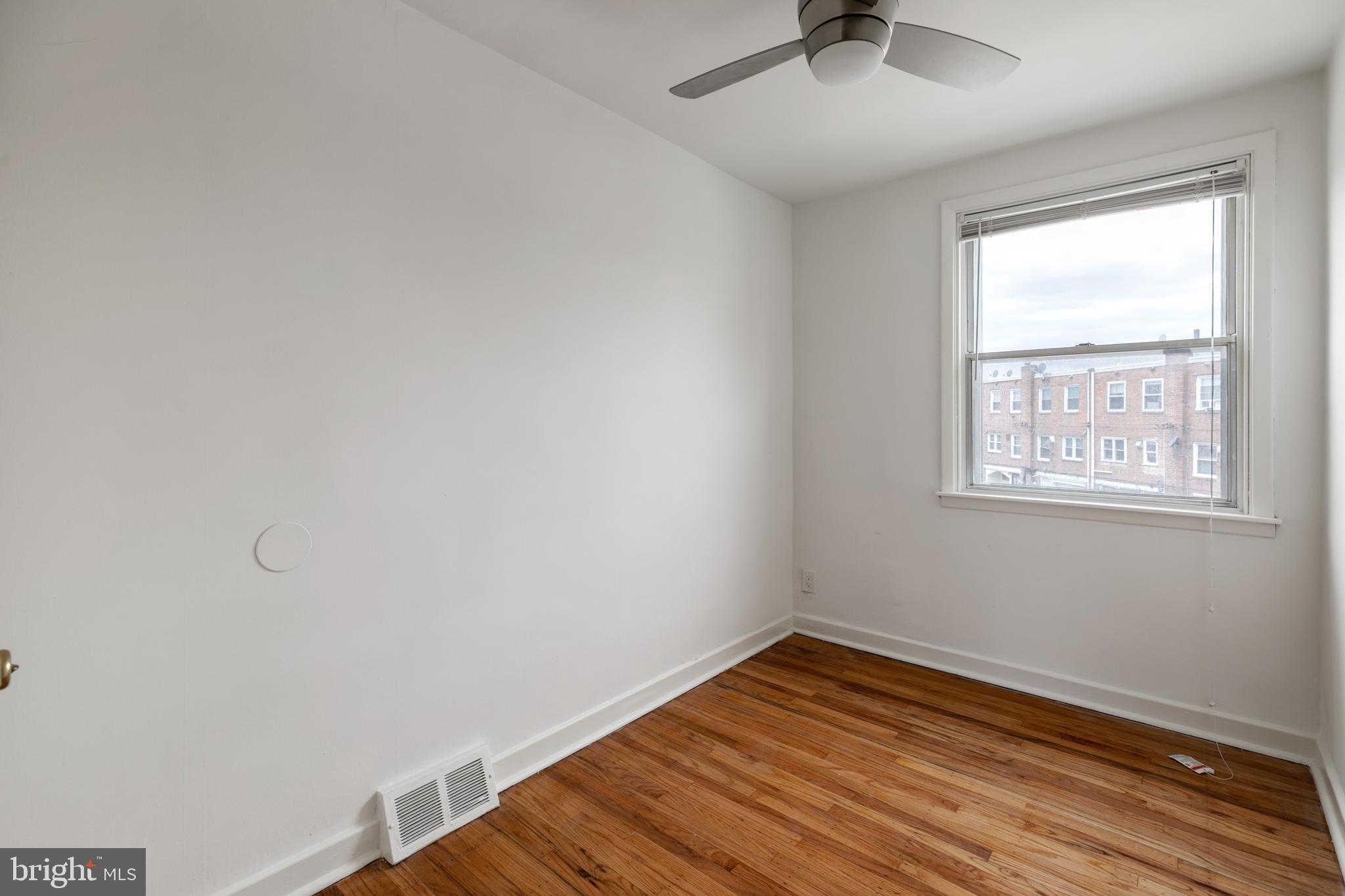 1828 South 29th Street Philadelphia, PA 19145 - Photo 22 of 32 wooden floor in an empty room with a window