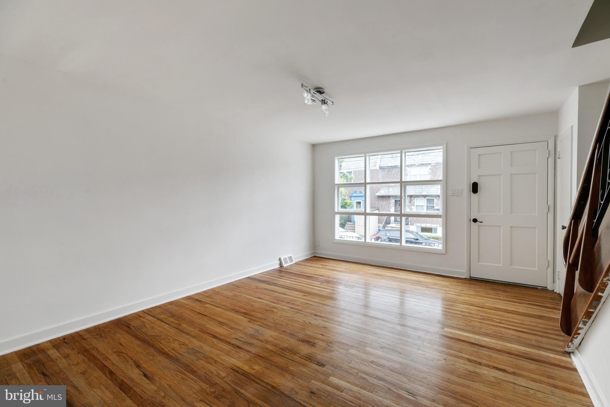1828 South 29th Street Philadelphia, PA 19145 - Photo 5 of 32 wooden floor in an empty room with a window