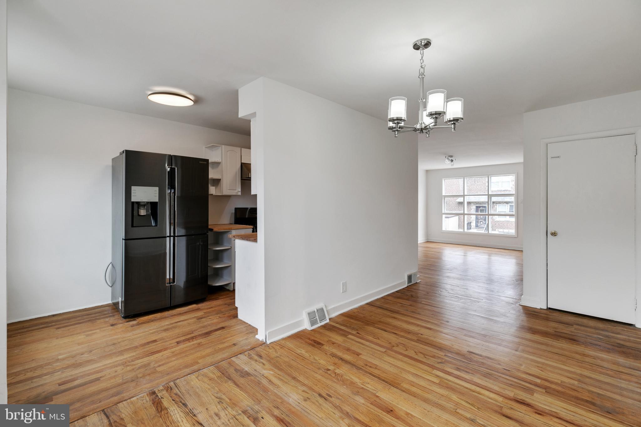 1828 South 29th Street Philadelphia, PA 19145 - Photo 8 of 32 a view of an empty room with window and wooden floor