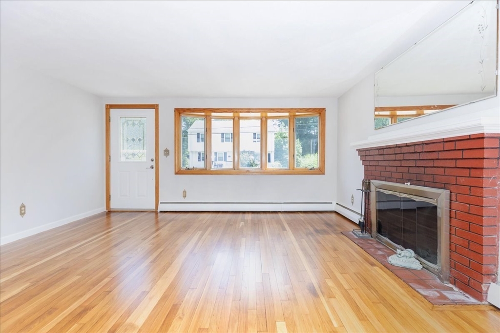 35 Rindone Street Holbrook, MA 02343 - Photo 11 of 37 an empty room with wooden floor fireplace and windows