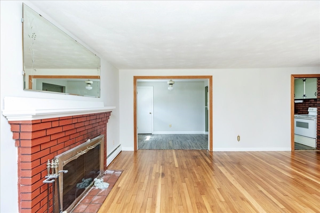 35 Rindone Street Holbrook, MA 02343 - Photo 12 of 37 a view of a room with wooden floor and staircase