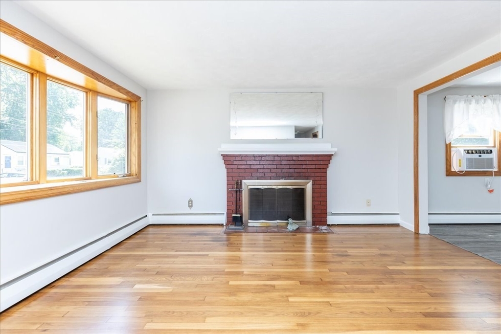 35 Rindone Street Holbrook, MA 02343 - Photo 6 of 37 a view of empty room with wooden floor and fireplace