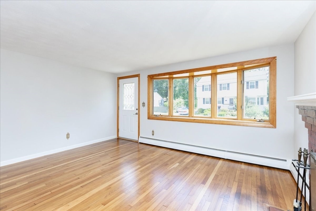 35 Rindone Street Holbrook, MA 02343 - Photo 8 of 37 a view of an empty room with wooden floor and a window