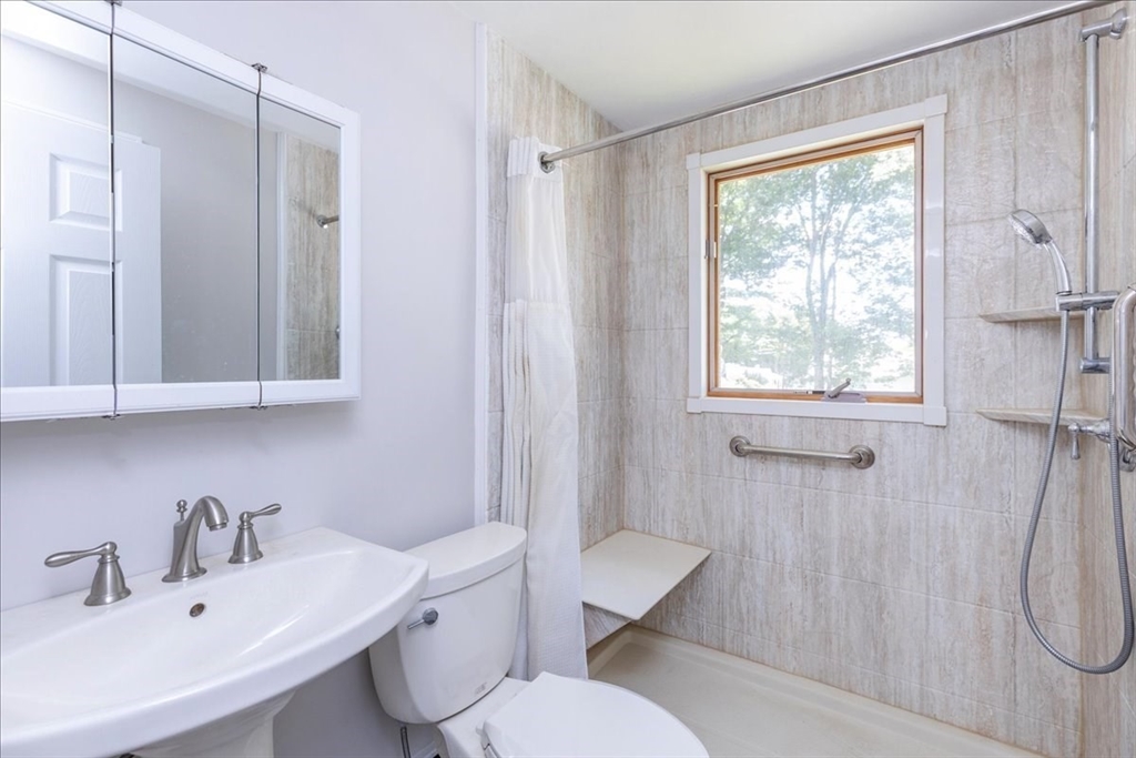 35 Rindone Street Holbrook, MA 02343 - Photo 10 of 37 a bathroom with a sink toilet a mirror and shower