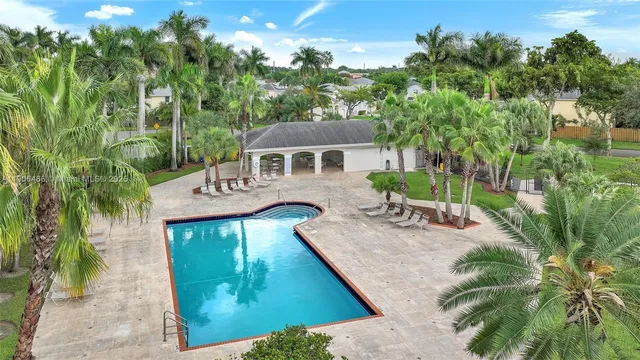 an aerial view of a house with swimming pool garden and patio