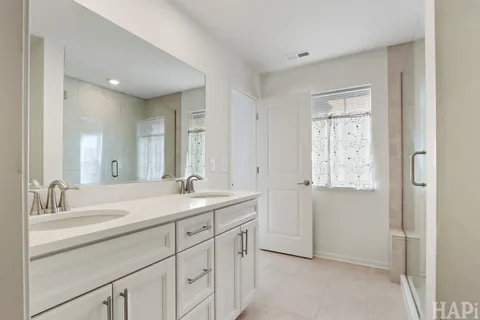 a bathroom with a shower a sink and toilet
