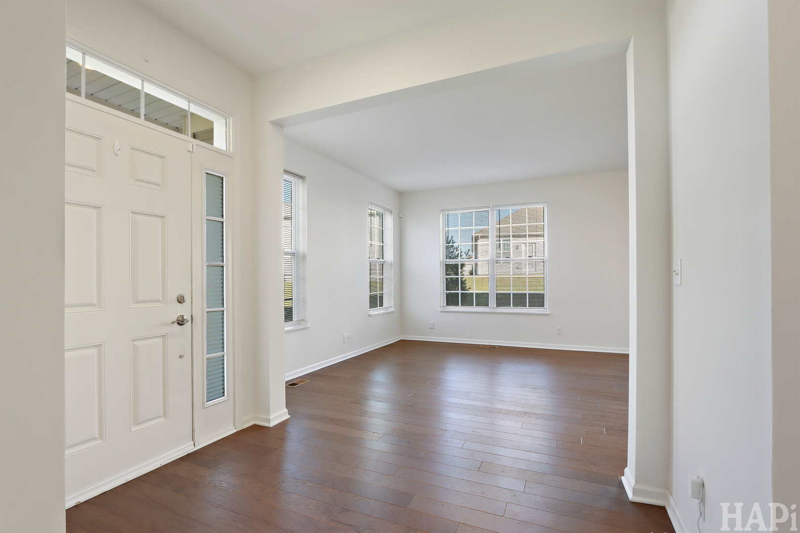 8426 Stillwater Road Wonder Lake, IL 60097 - Photo 9 of 32 a view of an empty room with wooden floor and a window