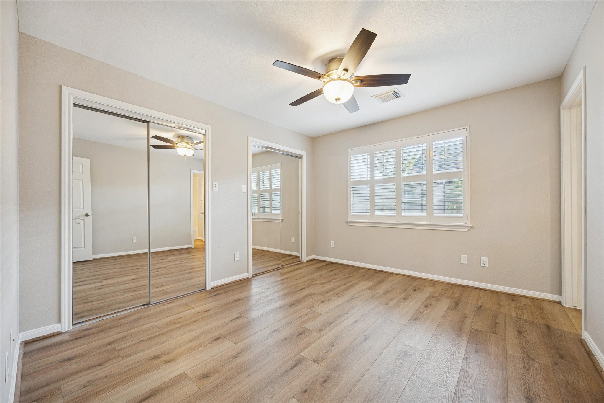 900 Eagle Lake Road Sealy, TX 77474 - Photo 11 of 15 a view of an empty room with wooden floor and a window