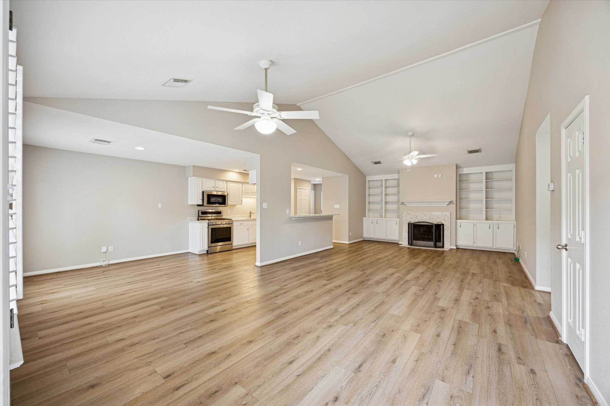 900 Eagle Lake Road Sealy, TX 77474 - Photo 5 of 15 a view of an empty room with wooden floor and a window
