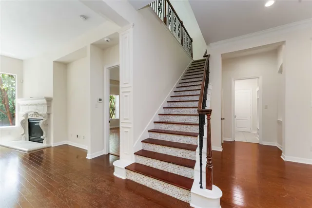 a view of entryway and hall with wooden floor