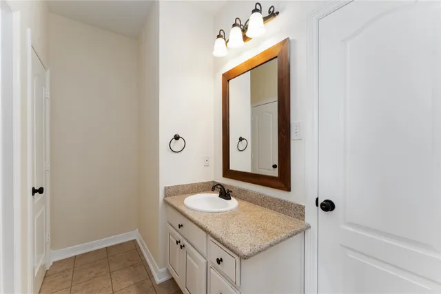 a bathroom with a sink vanity and a mirror