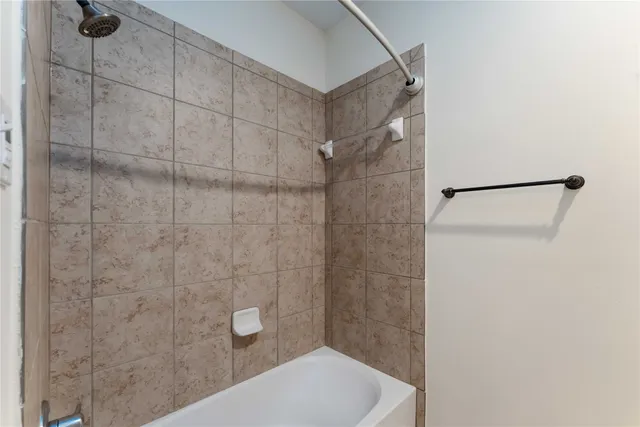 a bathroom with a shower and a toilet