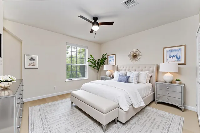 a bedroom with a large bed and a chandelier