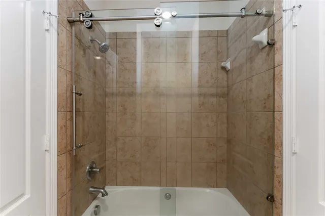 a bathroom with a shower and a bathtub