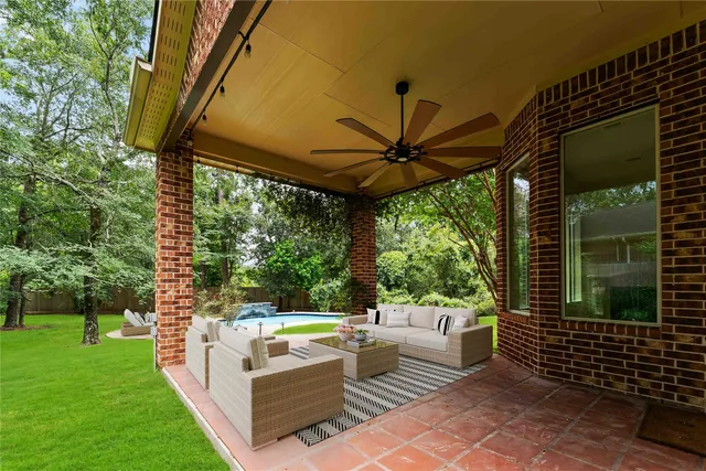 a view of a patio with a table chairs and a yard