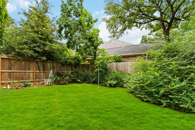 a garden with trees in front of it