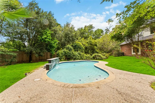 a view of a swimming pool with a yard