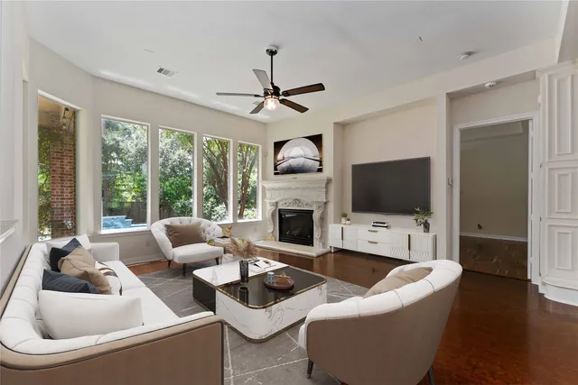 a living room with furniture a fireplace and a flat screen tv