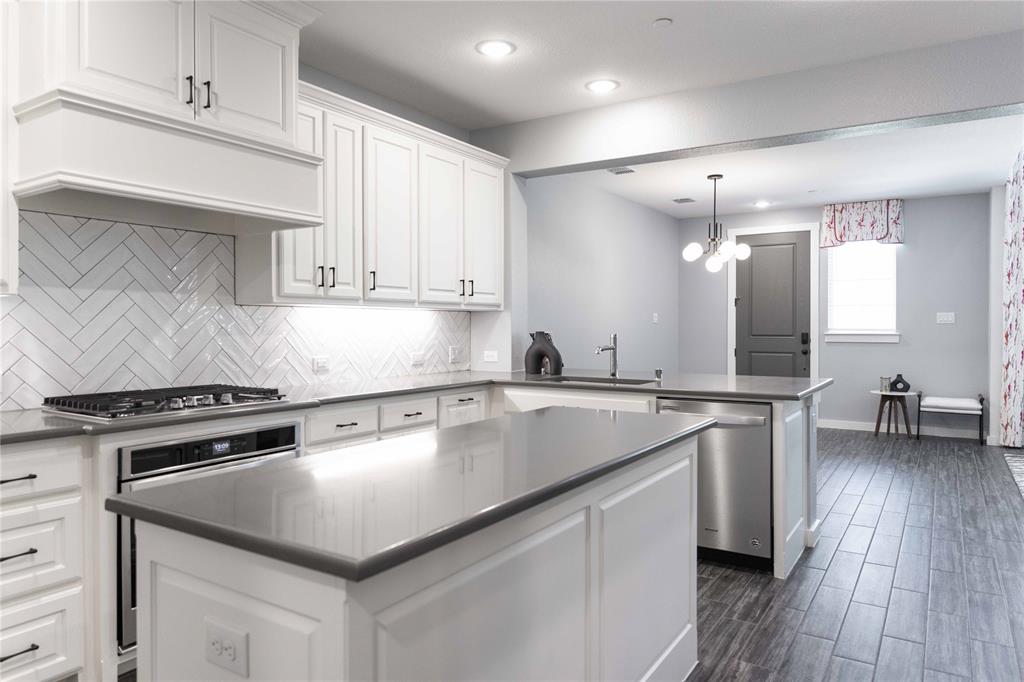 631 Cobblestone Lane Irving, TX 75039 - Photo 6 of 32 a kitchen with a stove a sink and a refrigerator