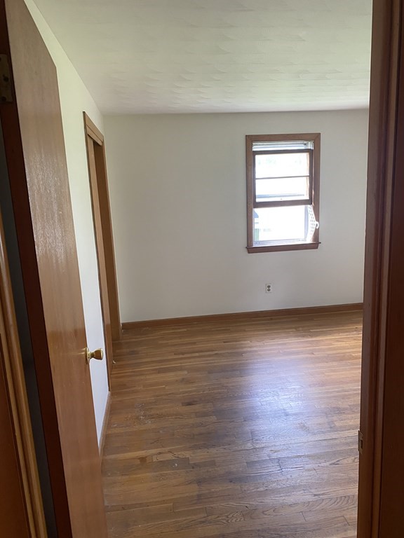 29 Justice Drive Amherst, MA 01002 - Photo 12 of 20 an empty room with wooden floor and windows
