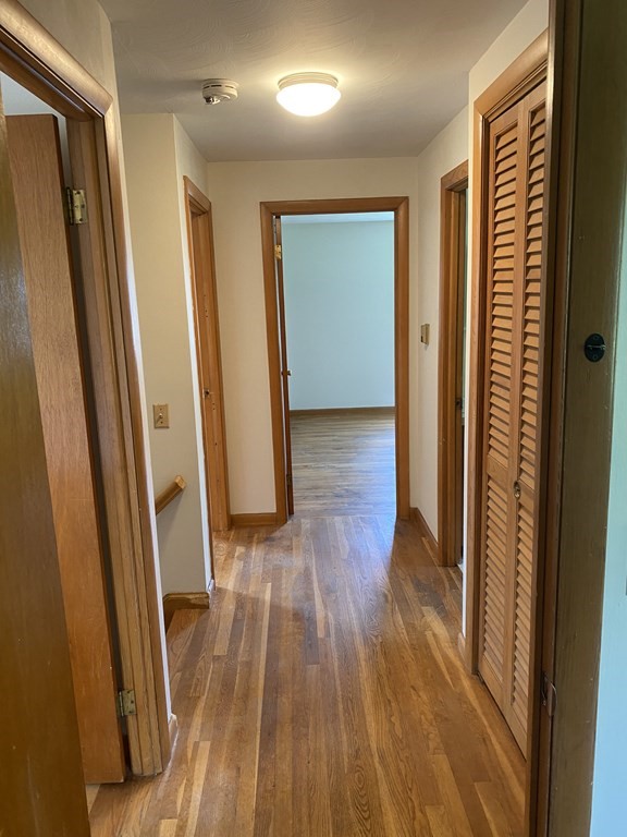 29 Justice Drive Amherst, MA 01002 - Photo 13 of 20 a view of a hallway with wooden floor and stairs