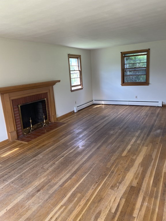 29 Justice Drive Amherst, MA 01002 - Photo 7 of 20 a view of an empty room with wooden floor and a window