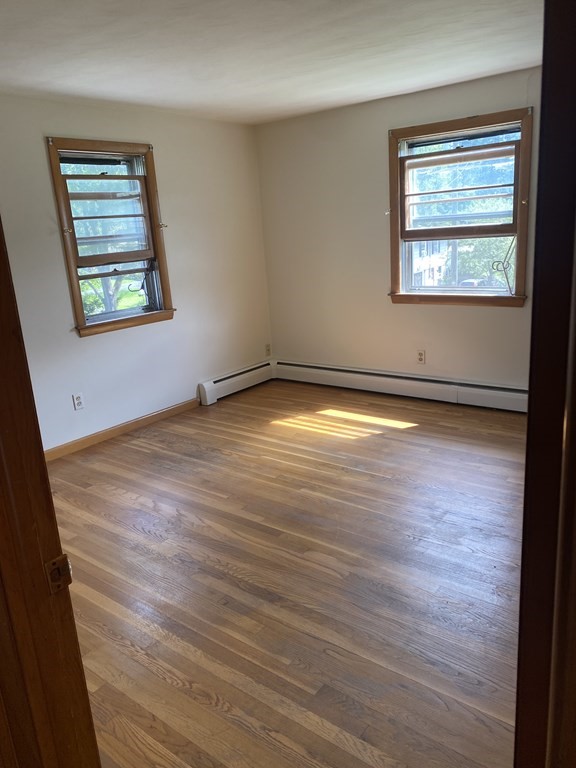 29 Justice Drive Amherst, MA 01002 - Photo 8 of 20 an empty room with wooden floor and windows