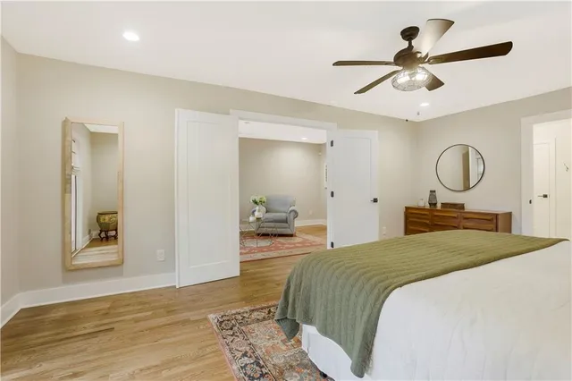 a bedroom with a large bed and a chandelier