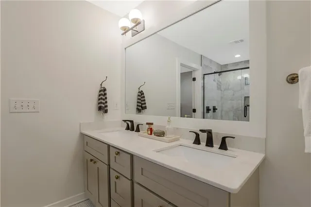 a bathroom with a sink vanity granite and a mirror
