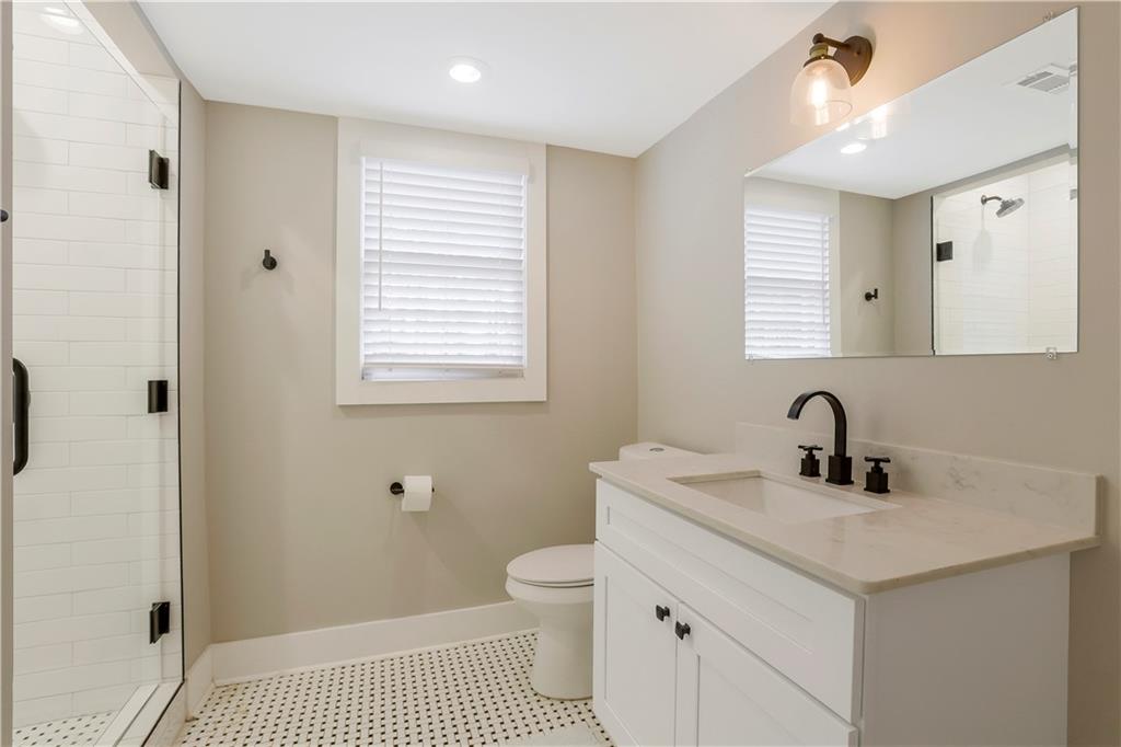1344 Midlawn Drive Decatur, GA 30032 - Photo 24 of 43 a bathroom with a sink a toilet and a mirror
