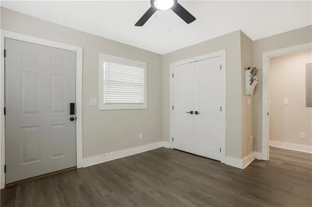 an empty room with wooden floor and window