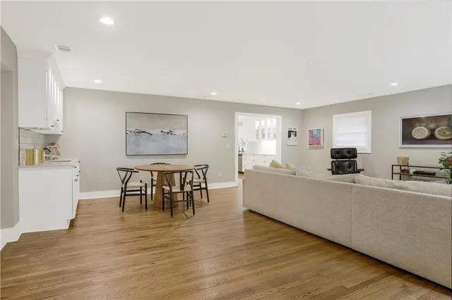 a living room with furniture a dining table and a stove top oven