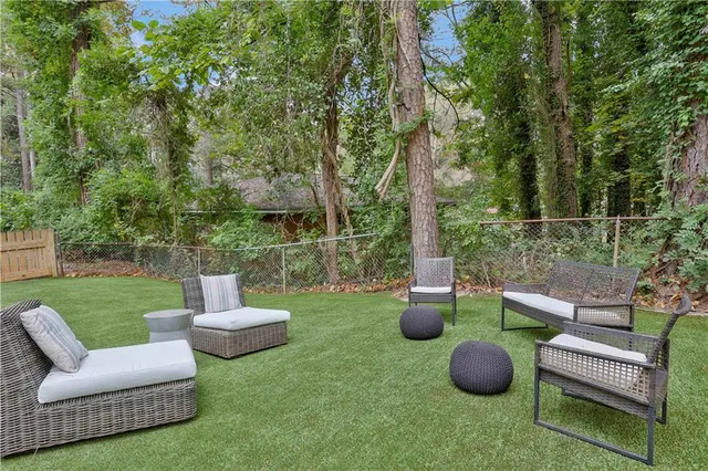 a view of a patio with chairs and a fire pit