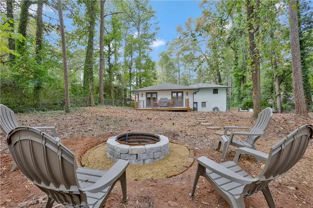 a view of house with backyard and furniture