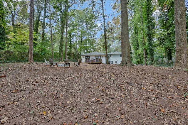 a view of a backyard with large trees