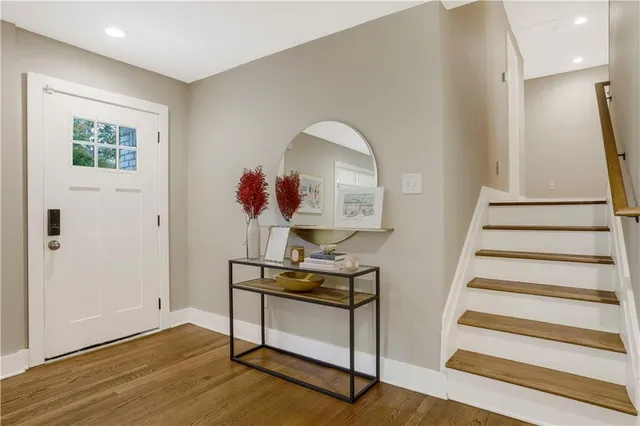 a view of entryway with stairs and wooden floor