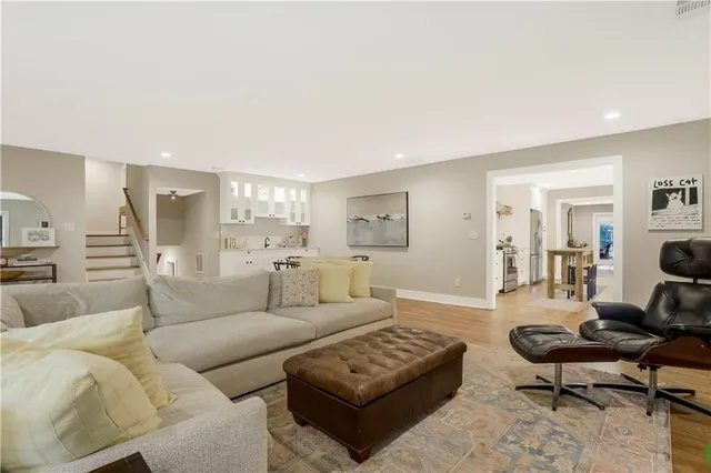 a living room with furniture wooden floor and a flat screen tv