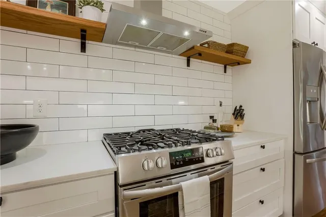 a kitchen with a stove and a refrigerator