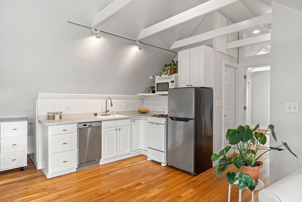 3 Circle Street, Unit 3 Marblehead, MA 01945 - Photo 8 of 23 a kitchen with a refrigerator and a stove top oven