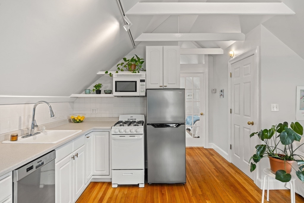 3 Circle Street, Unit 3 Marblehead, MA 01945 - Photo 9 of 23 a kitchen with a refrigerator and a stove top oven