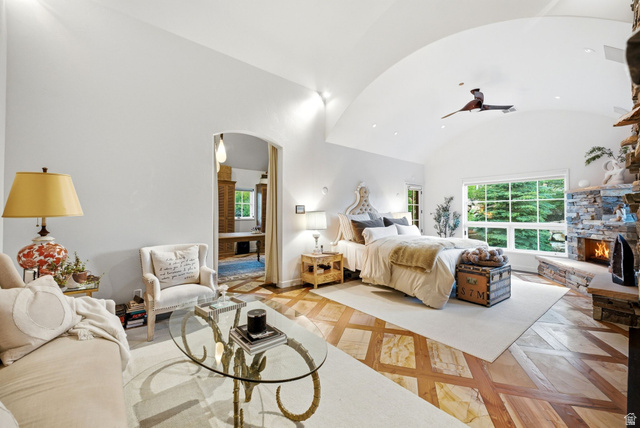 5971 Maple Ridge Trail Oakley, UT 84055 - Photo 23 of 43 Vaulted ceiling bedroom featuring a stone-clad fireplace and large picture window
