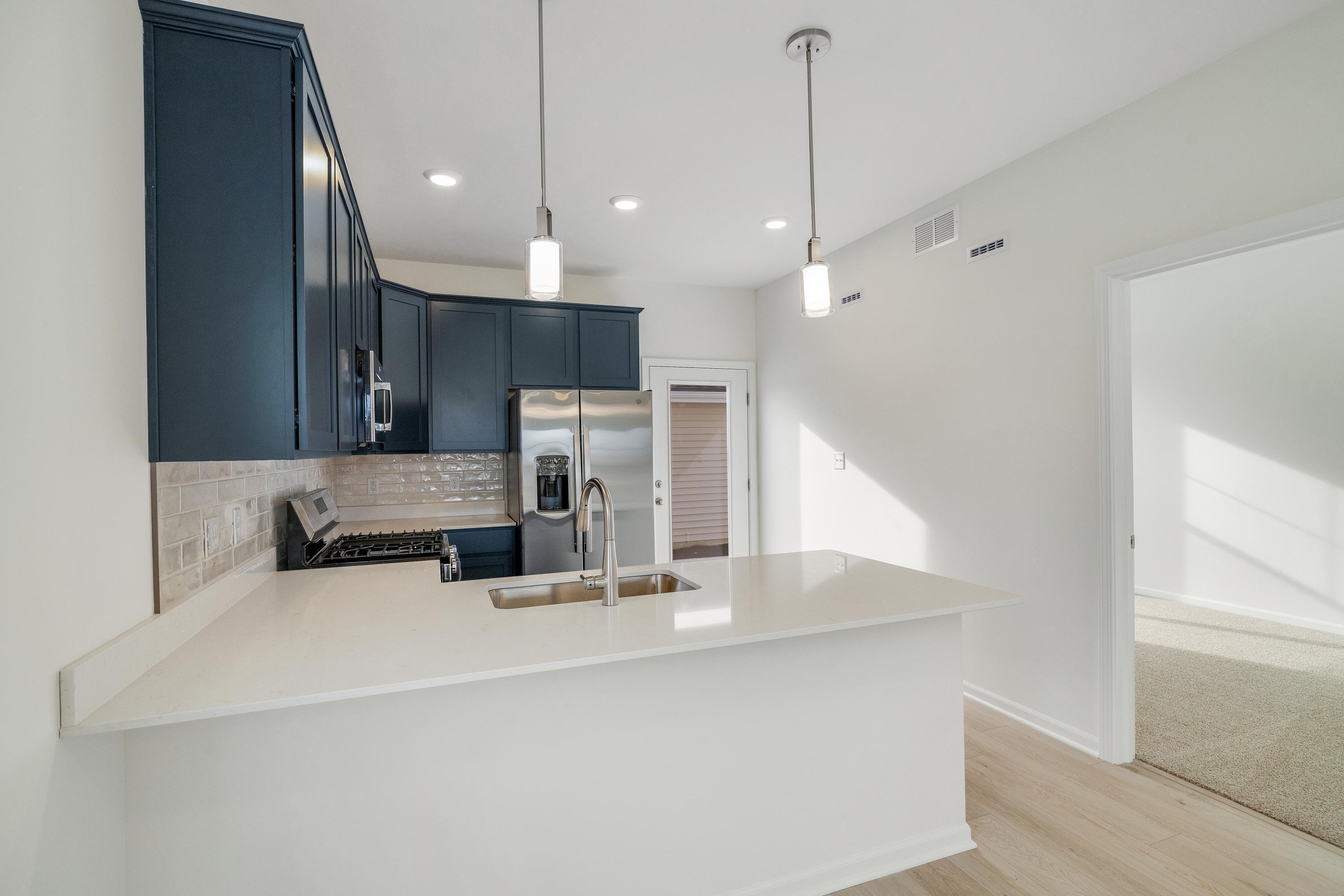 6141 Rushing Avenue Portage, IN 46368 - Photo 6 of 16 a kitchen with stainless steel appliances sink refrigerator and microwave