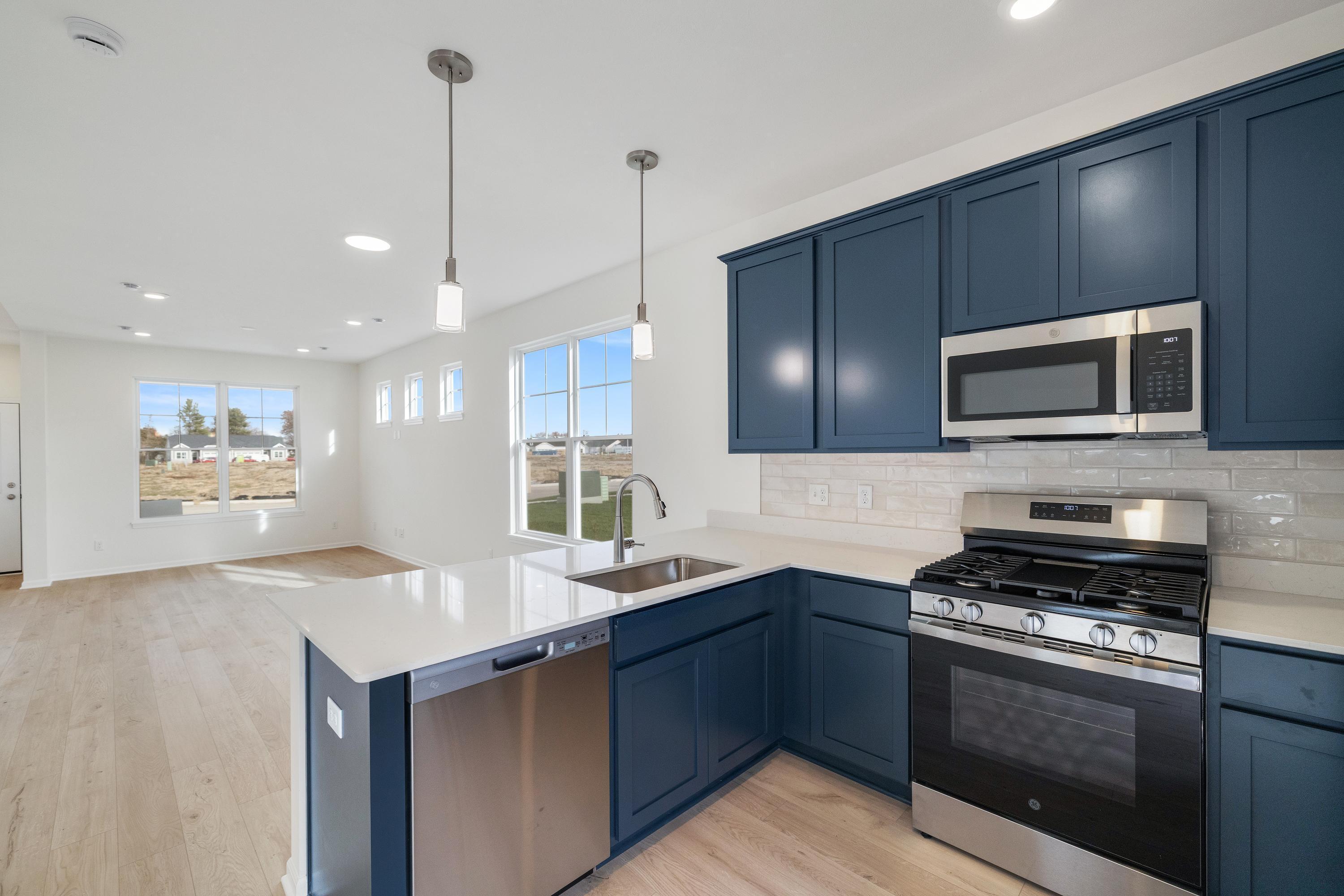 6141 Rushing Avenue Portage, IN 46368 - Photo 7 of 16 a kitchen with stainless steel appliances granite countertop a sink a stove a refrigerator and a oven with wooden floor