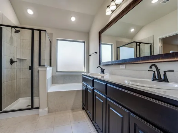 a large kitchen with granite countertop a sink and a refrigerator